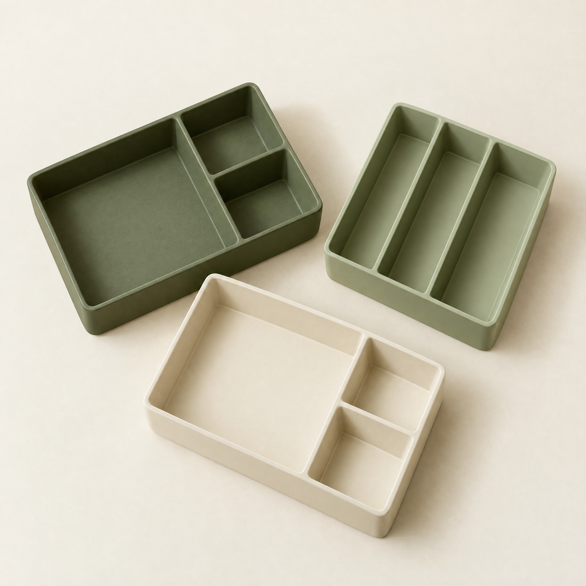 Generated concept image of three empty sage and cream divided drawer organizer trays