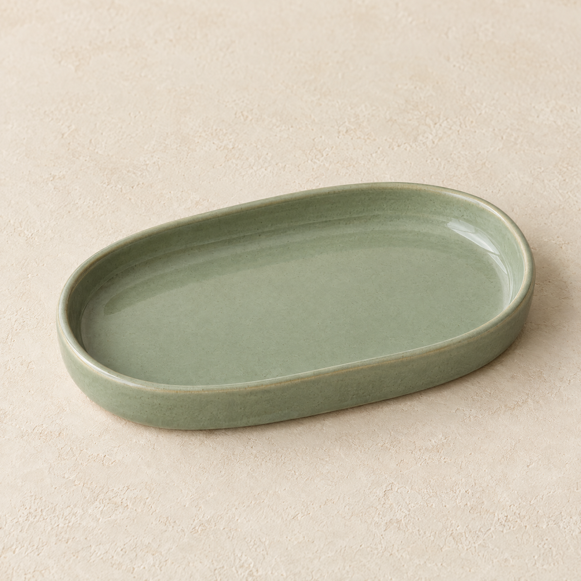 Generated concept image of an empty sage-green oval vanity catchall tray on a cream surface
